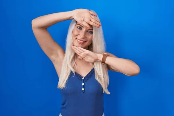 Caucasian Woman Standing Blue Background Smiling Cheerful Playing Peek Boo — Fotografia de Stock