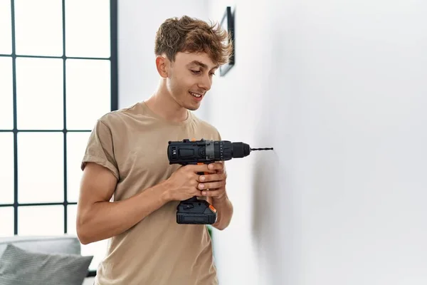Young Caucasian Man Smiling Confident Drilling Wall Home — Stok fotoğraf