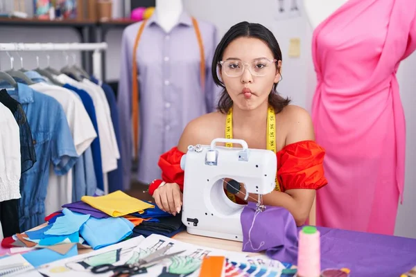 Hispanic Young Woman Dressmaker Designer Using Sewing Machine Making Fish — Stockfoto