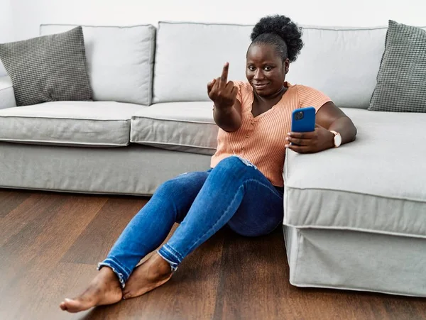 Young African Woman Using Smartphone Sitting Floor Home Showing Middle — 图库照片