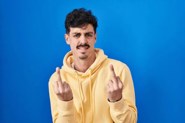 Hispanic Man Standing Blue Background Showing Middle Finger Doing Fuck — Stockfoto