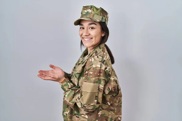 Młoda Południowoazjatycka Kobieta Mundurze Wojskowym Kamuflażem Skierowanym Bok Otwartymi Dłońmi — Zdjęcie stockowe