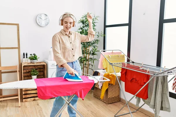 Young Caucasian Woman Listening Music Ironing Clothes Laundry Room —  Fotos de Stock