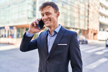 Young man business worker smiling confident talking on smartphone at street