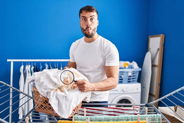 Handsome Hispanic Man Holding Magnifying Glass Looking Stain Clothes Making — Zdjęcie stockowe