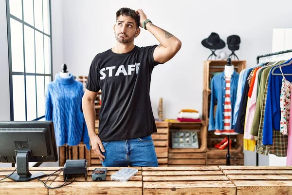 Young Hispanic Man Working Retail Boutique Confuse Wondering Question Uncertain — kuvapankkivalokuva