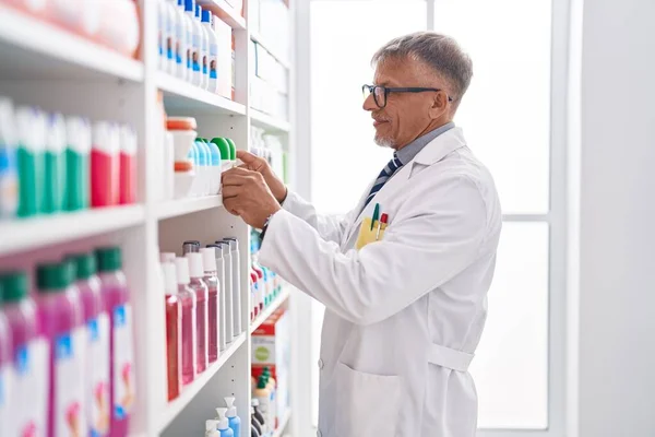 Middle Age Grey Haired Man Pharmacist Holding Deodorant Bottle Laboratory — Stock Photo, Image