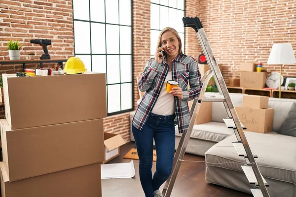 Young Blonde Woman Talking Smartphone Drinking Coffee New Home — Stockfoto