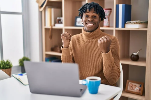 Young African Man Dreadlocks Working Using Computer Laptop Celebrating Surprised — Stock fotografie