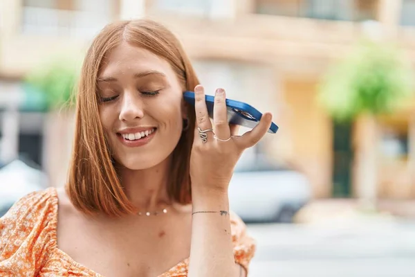 Young Redhead Woman Smiling Confident Listening Audio Message Smartphone Street — Zdjęcie stockowe