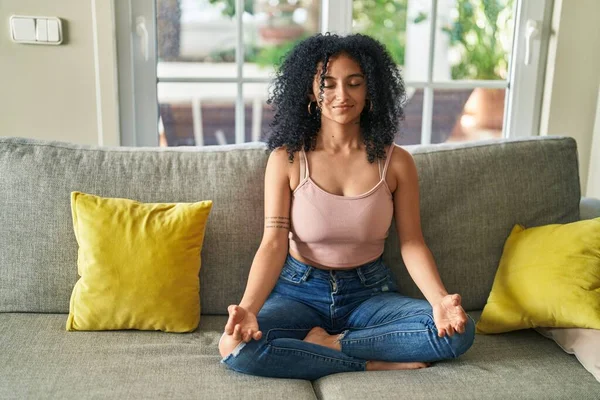 Young Hispanic Woman Doing Yoga Exercise Sitting Sofa Home — Stockfoto