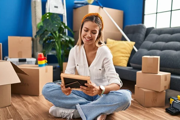 Jonge Spaanse Vrouw Zoek Foto Zittend Vloer Bij Nieuw Huis — Stockfoto