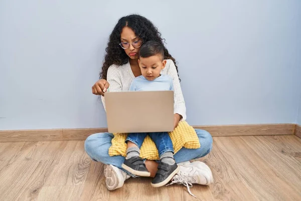 Young Hispanic Mother Kid Using Computer Laptop Sitting Floor Pointing — Stok fotoğraf