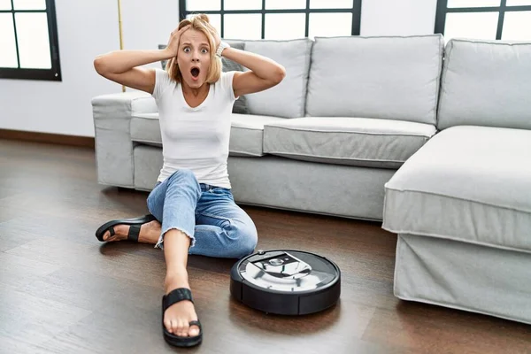 Young Caucasian Woman Sitting Home Vacuum Robot Crazy Scared Hands — Stockfoto