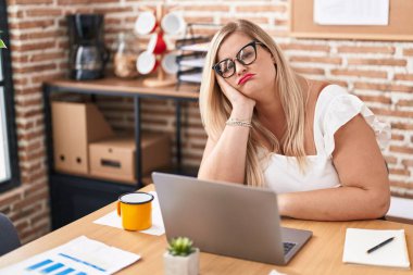 Young woman business worker boring using laptop working at office