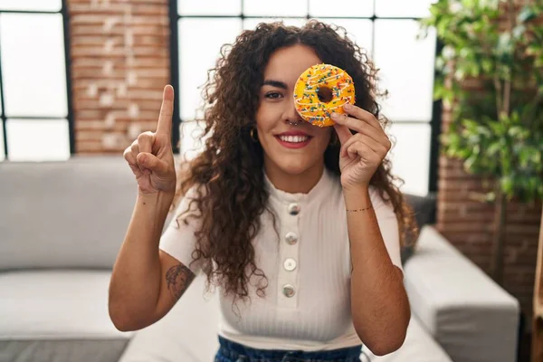 Young Hispanic Woman Holding Tasty Colorful Doughnut Eye Smiling Idea — Stockfoto