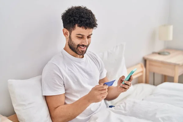 Young Arab Man Using Smartphone Credit Card Sitting Bed Bedroom — Photo