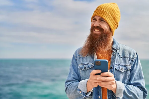 Young Redhead Man Smiling Confident Using Smartphone Seaside — Stok fotoğraf