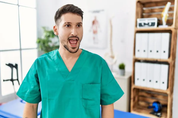 Young Physiotherapist Man Working Pain Recovery Clinic Angry Mad Screaming — Stock Photo, Image
