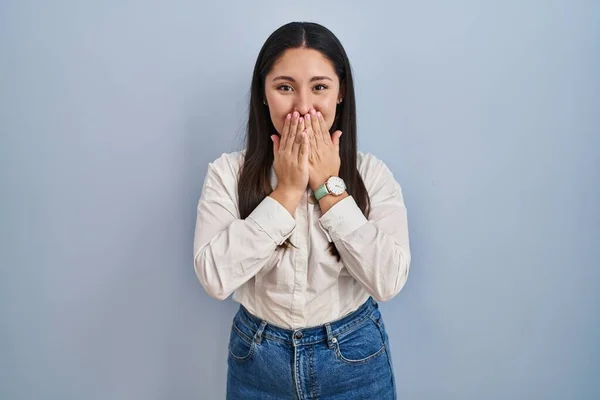 Young Latin Woman Standing Blue Background Laughing Embarrassed Giggle Covering — Zdjęcie stockowe