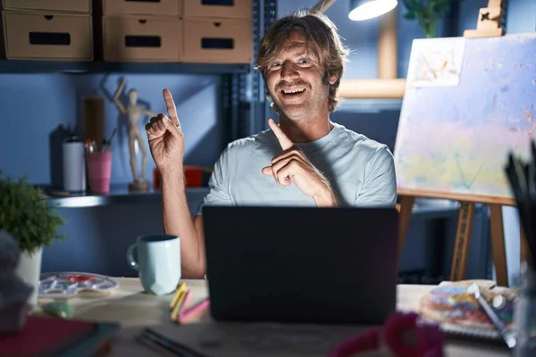Middle Age Man Sitting Art Studio Laptop Night Smiling Looking — Stock Photo, Image