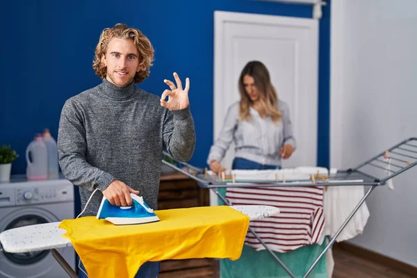 Couple Ironing Clothes Laundry Room Doing Sign Fingers Smiling Friendly — Stok fotoğraf