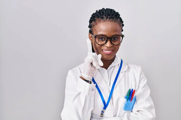 African Woman Braids Wearing Scientist Uniform Smiling Idea Question Pointing — Stockfoto