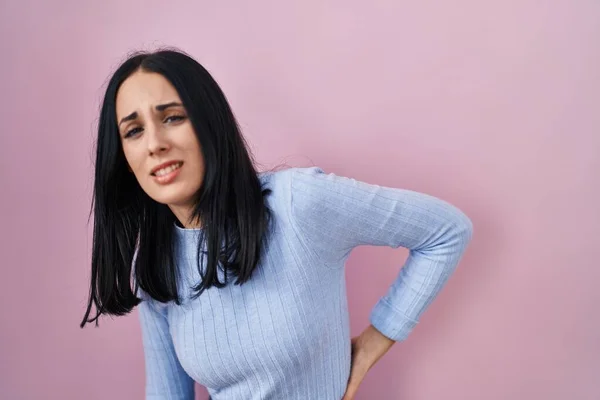 Hispanic Woman Standing Pink Background Suffering Backache Touching Back Hand — Zdjęcie stockowe