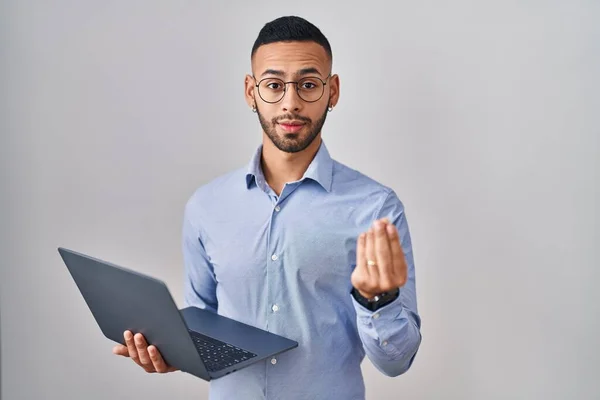 Young Hispanic Man Working Using Computer Laptop Doing Money Gesture — Stok fotoğraf