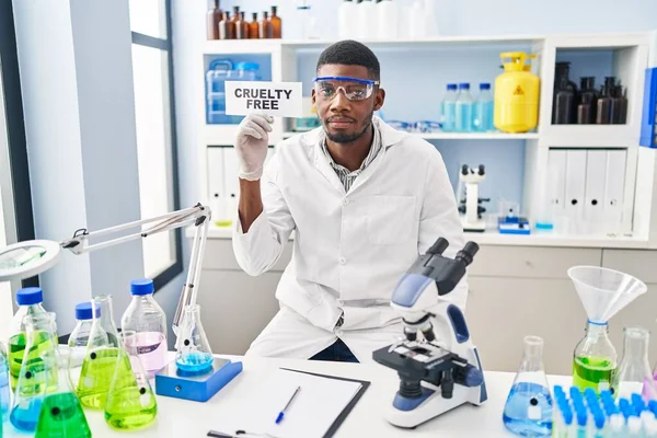 African american man working on cruelty free laboratory thinking attitude and sober expression looking self confident 