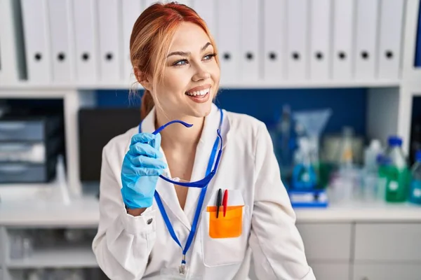 Joven Mujer Caucásica Científica Sonriendo Confiada Sosteniendo Gafas Laboratorio —  Fotos de Stock