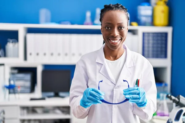 African American Woman Scientist Smiling Confident Holding Glasses Laboratory — Fotografia de Stock