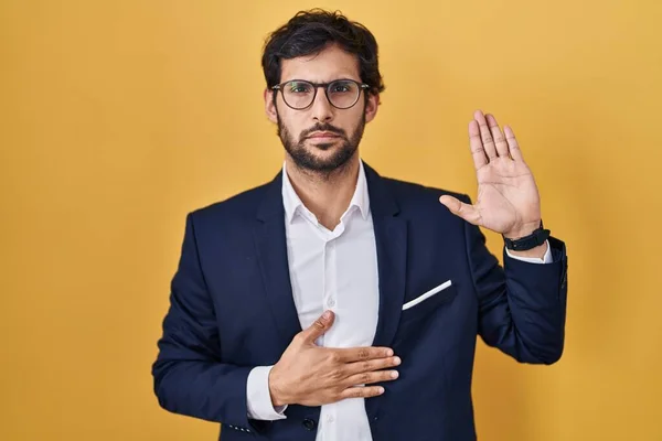 Handsome Latin Man Standing Yellow Background Swearing Hand Chest Open — Stockfoto