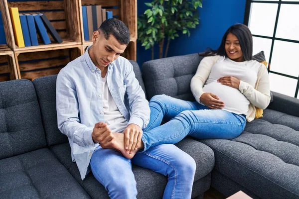 Young Latin Couple Expecting Baby Massaging Foot Home — Photo