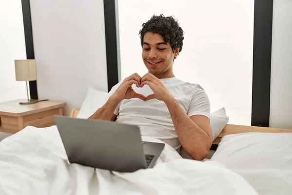 Latin Asıllı Genç Bir Adam Yatak Odasında Elleri Ile Kalp — Stok fotoğraf