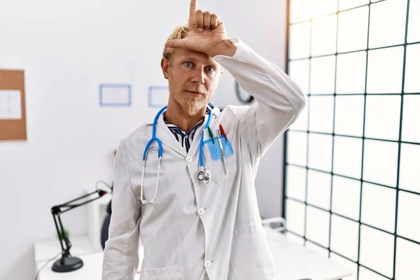 Young Blond Man Wearing Doctor Uniform Stethoscope Clinic Making Fun — 图库照片