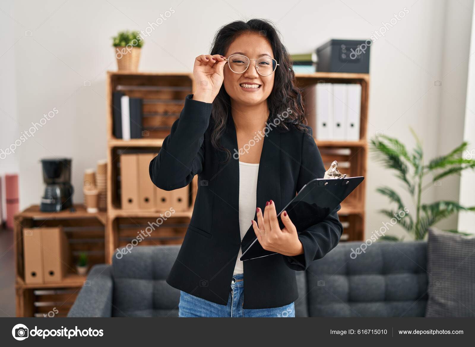 Young Chinese Woman Psychologist Holding Clipboard Standing Clinic Stock Photo by ©Krakenimages