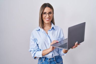 Young woman working using computer laptop with a happy and cool smile on face. lucky person. 