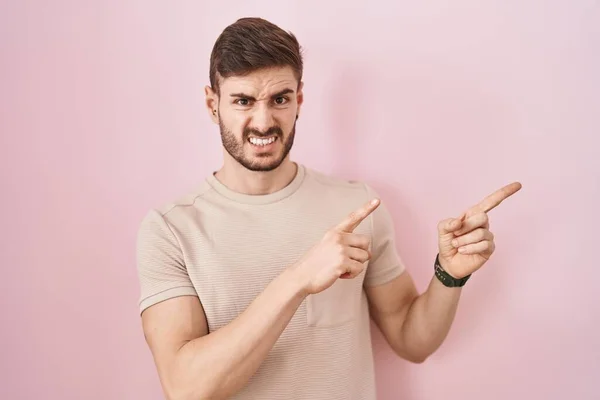 Hispanic Man Beard Standing Pink Background Pointing Aside Worried Nervous — Stockfoto