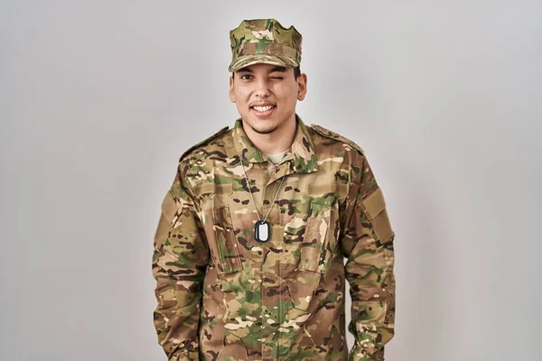 Young Arab Man Wearing Camouflage Army Uniform Winking Looking Camera — Stockfoto