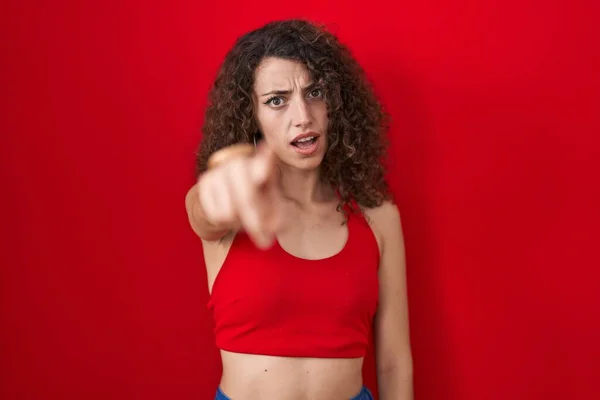 Hispanic Woman Curly Hair Standing Red Background Pointing Displeased Frustrated — Photo