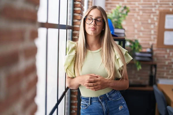 Young beautiful hispanic woman business worker standing with relaxed expression at office