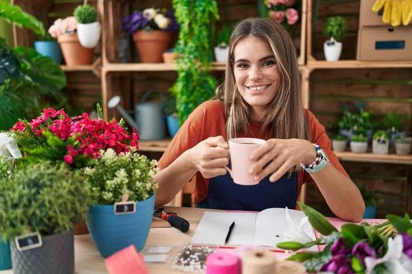 Young Beautiful Hispanic Woman Florist Smiling Confident Drinking Coffee Flower — Zdjęcie stockowe