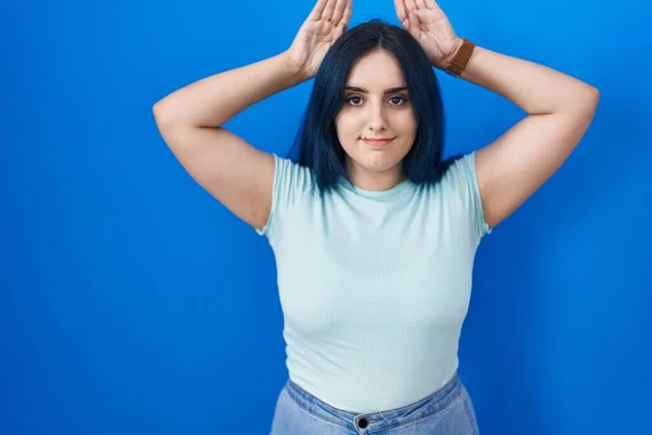 Young Modern Girl Blue Hair Standing Blue Background Doing Bunny — Foto de Stock