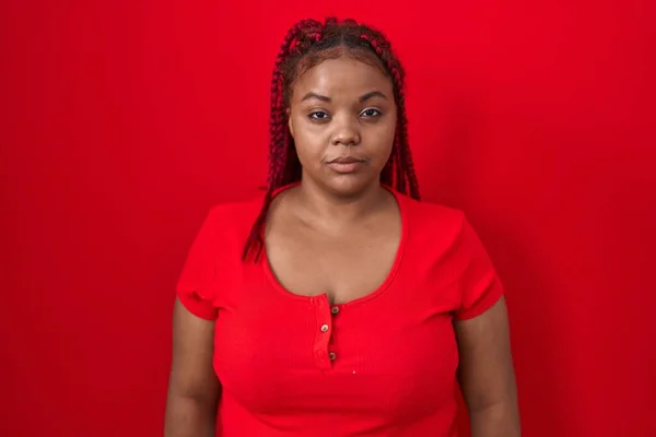 African American Woman Braided Hair Standing Red Background Relaxed Serious — Stock fotografie