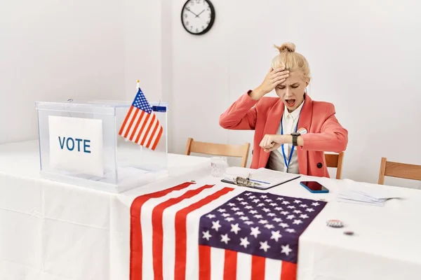 Beautiful caucasian woman working at political campaign looking at the watch time worried, afraid of getting late