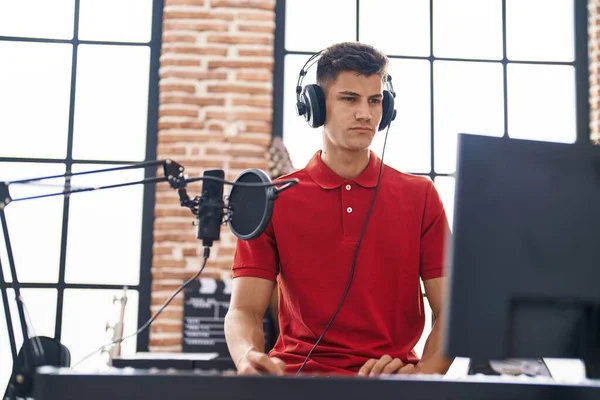 Young Hispanic Man Musician Playing Piano Relaxed Expression Music Studio — Stockfoto