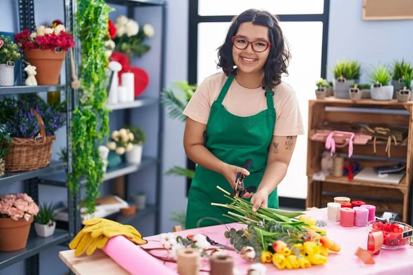 Young woman florist make bouquet of flowers at florist