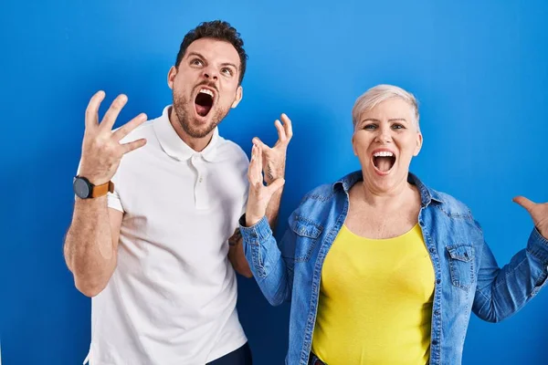 Young Brazilian Mother Son Standing Blue Background Crazy Mad Shouting — Stok fotoğraf