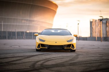 Wroclaw, Poland - May 6, 2020: Front view of beautiful yellow Lamborghini Huracan Evo Spyder. It is very fast and luxurious car with V10 engine.